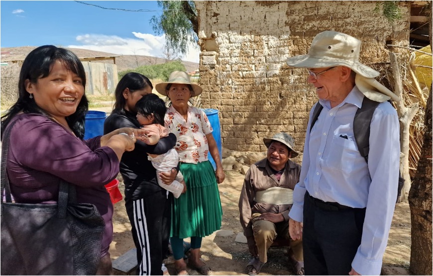 Eddie and Project Manager Sandra visiting a beneficiary and their family